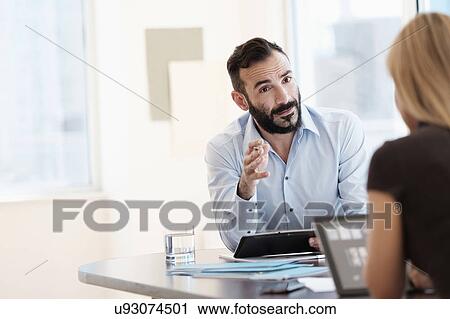 Man and woman talking in office View Large Photo Image Stock Image - Man and woman talking in office. Fotosearch