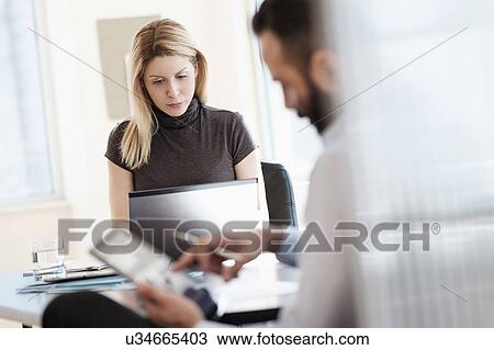 Stock Image - Man and woman working in office. Fotosearch