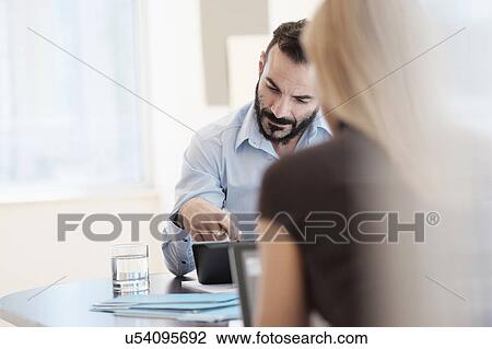 Stock Image - Man and woman working in office. Fotosearch