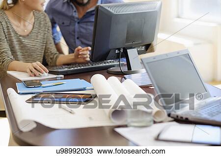 Man and woman working in office View Large Photo Image Stock Image - Man and woman working in office. Fotosearch