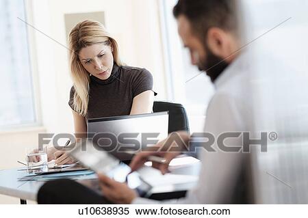 Man and woman working in office View Large Photo Image Stock Photography - Man and woman working in office. Fotosearch