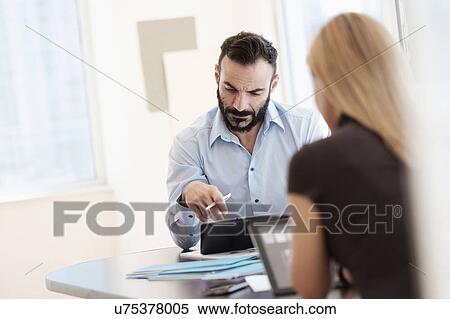 Man and woman working in office View Large Photo Image Stock Photography - Man and woman working in office. Fotosearch