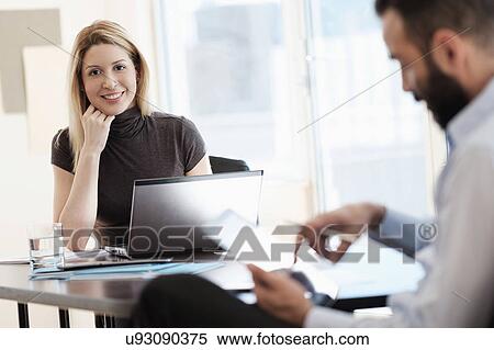 Stock Photography - Man and woman working in office. Fotosearch