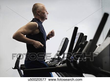 Man exercising in health club using treadmill View Large Photo Image Stock Photo - Man exercising in health club using treadmill. Fotosearch