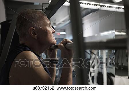 Man in health club doing chin-ups View Large Photo Image Stock Image - Man in health club doing chin-ups. Fotosearch