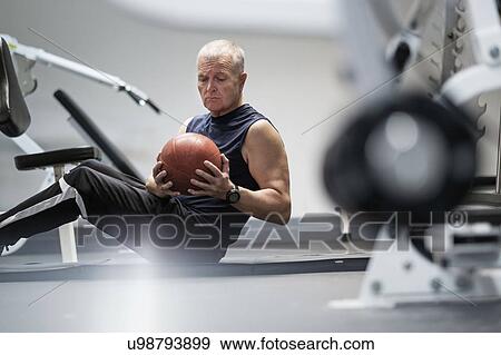 Man in health club exercising with ball View Large Photo Image Stock Photo - Man in health club exercising with ball. Fotosearch