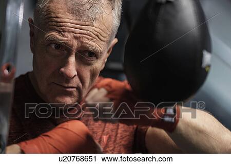 Man in health club hitting speed bag View Large Photo Image Stock Image - Man in health club hitting speed bag. Fotosearch