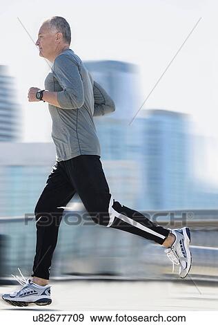 Man jogging in city View Large Photo Image Stock Photo - Man jogging in city. Fotosearch