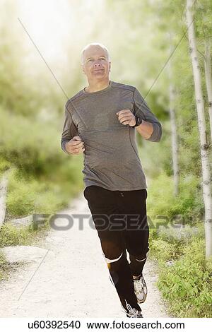 Man jogging on path in park View Large Photo Image Stock Image - Man jogging on path in park. Fotosearch