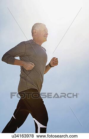 Stock Photo - Man jogging outdoors. Fotosearch