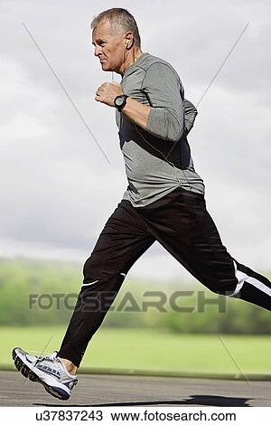 Stock Image - Man running outdoors. Fotosearch