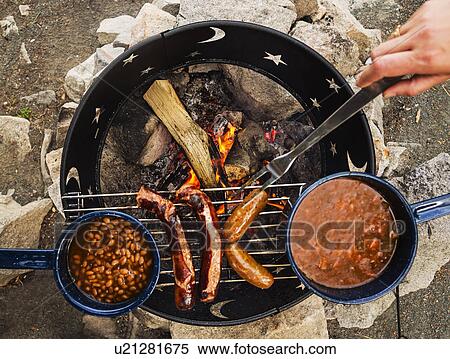 Man's hand cooking dinner on camp fire View Large Photo Image Stock Photography - Man's hand cooking dinner on camp fire. Fotosearch
