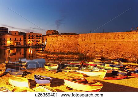 Stock Image - Marina and Castello Angiono at sunrise. Fotosearch