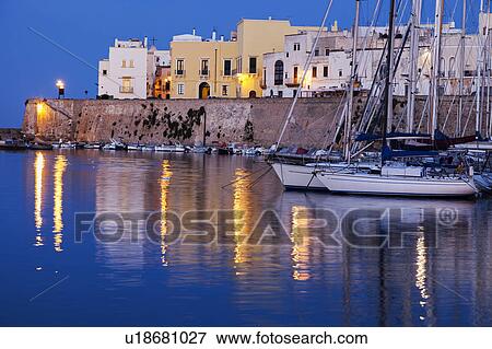 Stock Photo - Marina and Castello Angiono at sunrise. Fotosearch