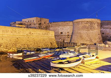 Stock Photo - Marina and Castello Angiono at sunrise. Fotosearch