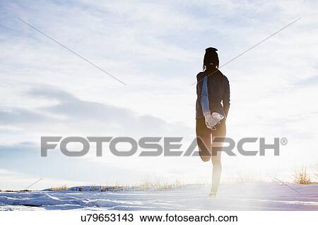 Mature woman stretching in snow View Large Photo Image Stock Image - Mature woman stretching in snow. Fotosearch