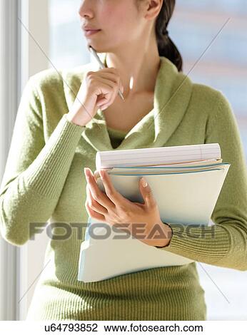 Mid section of business woman holding documents View Large Photo Image Stock Image - Mid section of business woman holding documents. Fotosearch