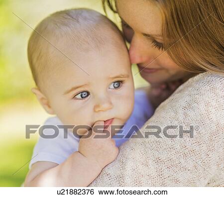 Mother holding baby boy (6-11 months) View Large Photo Image Stock Photograph - Mother holding baby boy (6-11 months). Fotosearch