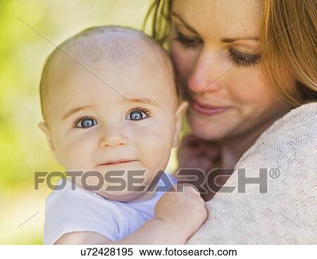Mother holding baby boy (6-11 months) View Large Photo Image Stock Photography - Mother holding baby boy (6-11 months). Fotosearch