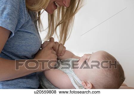 Mother holding hands of baby daughter (12-17 months) View Large Photo Image Stock Photo - Mother holding hands of baby daughter (12-17 months). Fotosearch