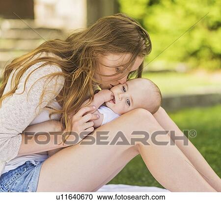 Mother kissing baby (6-11 months) View Large Photo Image Stock Image - Mother kissing baby (6-11 months). Fotosearch