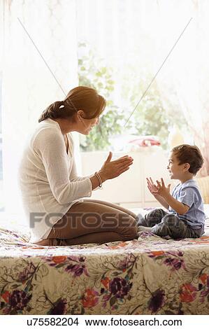 Mother playing with son (2-3) on bed View Large Photo Image Picture - Mother playing with son (2-3) on bed. Fotosearch