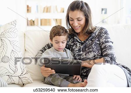 Mother reading with son (2-3) on sofa View Large Photo Image Stock Image - Mother reading with son (2-3) on sofa. Fotosearch