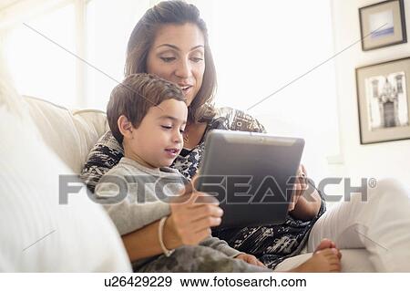 Mother reading with son (2-3) on sofa View Large Photo Image Stock Photo - Mother reading with son (2-3) on sofa. Fotosearch