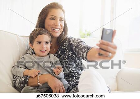 Stock Photo - Mother taking selfie son (2-3). Fotosearch