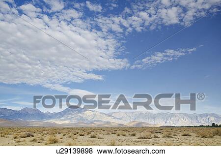Mountain landscape and cloudy sky View Large Photo Image Stock Photo - Mountain landscape and cloudy sky. Fotosearch