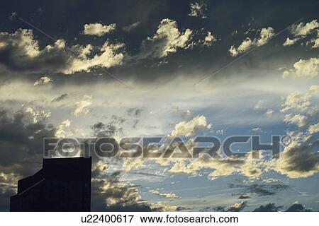 Stock Photo - Office building against dramatic sky. Fotosearch