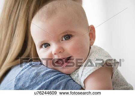 Stock Photo - Portrait of baby girl (12-17 months) with mother. Fotosearch
