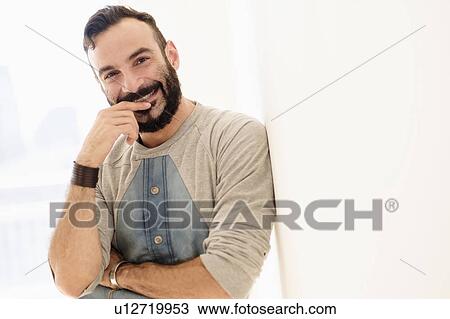 Stock Image - Portrait of bearded man looking at camera. Fotosearch