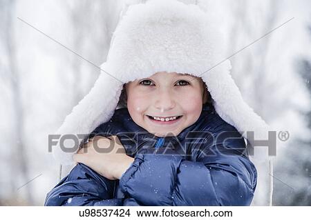 Portrait of boy (6-7) in fur hat View Large Photo Image Picture - Portrait of boy (6-7) in fur hat. Fotosearch