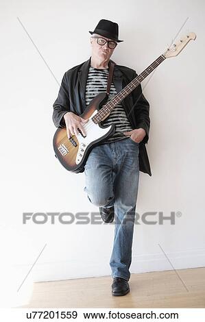 Portrait of cool man with bass guitar View Large Photo Image Stock Photo - Portrait of cool man with bass guitar. Fotosearch