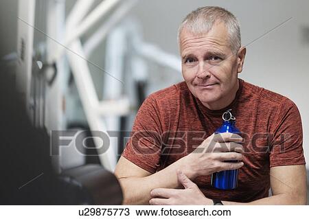 Portrait of man in health club with water bottle View Large Photo Image Stock Image - Portrait of man in health club with water bottle. Fotosearch