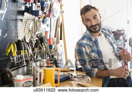 Stock Image - Portrait of man in workshop. Fotosearch
