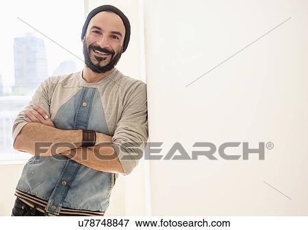 Stock Photo - Portrait of man leaning on wall. Fotosearch