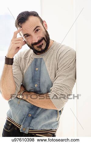 Portrait of man leaning on wall View Large Photo Image Stock Photo - Portrait of man leaning on wall. Fotosearch