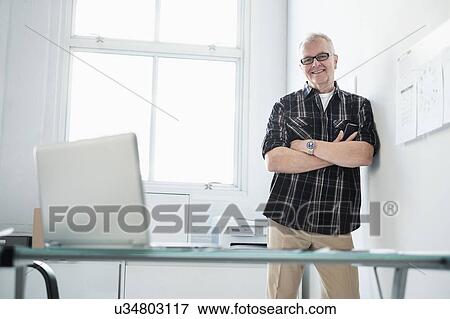 Stock Photo - Portrait of smiling man in modern office. Fotosearch