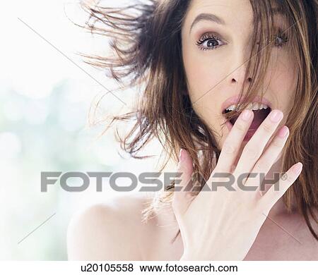 Stock Photo - Portrait of surprised beautiful woman with brown hair. Fotosearch
