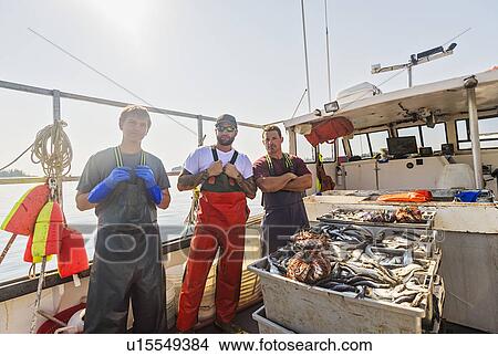 Picture - Portrait of three fishermen standing on boat. Fotosearch