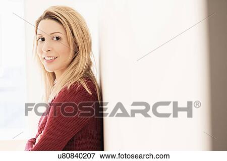 Stock Photo - Portrait of young woman looking at camera. Fotosearch