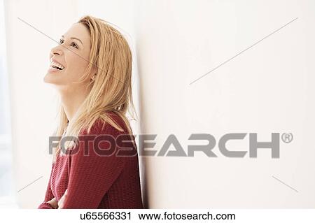 Portrait of young woman looking up and laughing View Large Photo Image Stock Image - Portrait of young woman looking up and laughing. Fotosearch