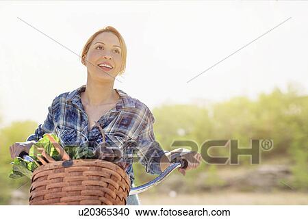 Portrait of young woman with bicycle View Large Photo Image Stock Image - Portrait of young woman with bicycle. Fotosearch
