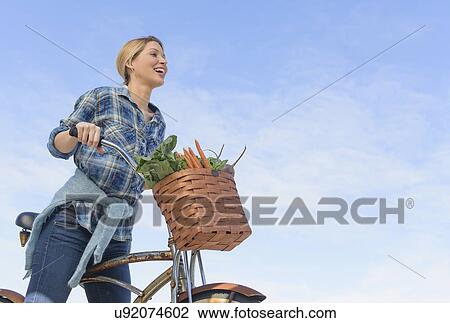 Portrait of young woman with bicycle View Large Photo Image Stock Image - Portrait of young woman with bicycle. Fotosearch