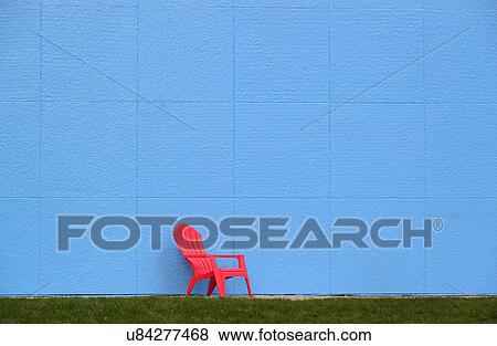 Red chair by blue wall View Large Photo Image Stock Photo - Red chair by blue wall. Fotosearch