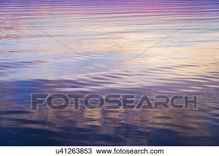 Rippled water reflecting colorful light View Large Photo Image Stock Image - Rippled water reflecting colorful light. Fotosearch