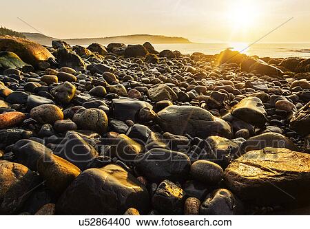 Rocks on beach at sunrise View Large Photo Image Stock Image - Rocks on beach at sunrise. Fotosearch