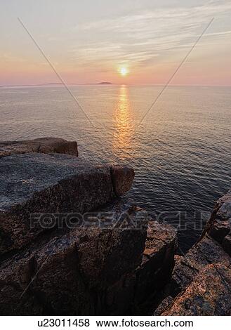 Rocky cliff by sea at sunrise View Large Photo Image Stock Photo - Rocky cliff by sea at sunrise. Fotosearch